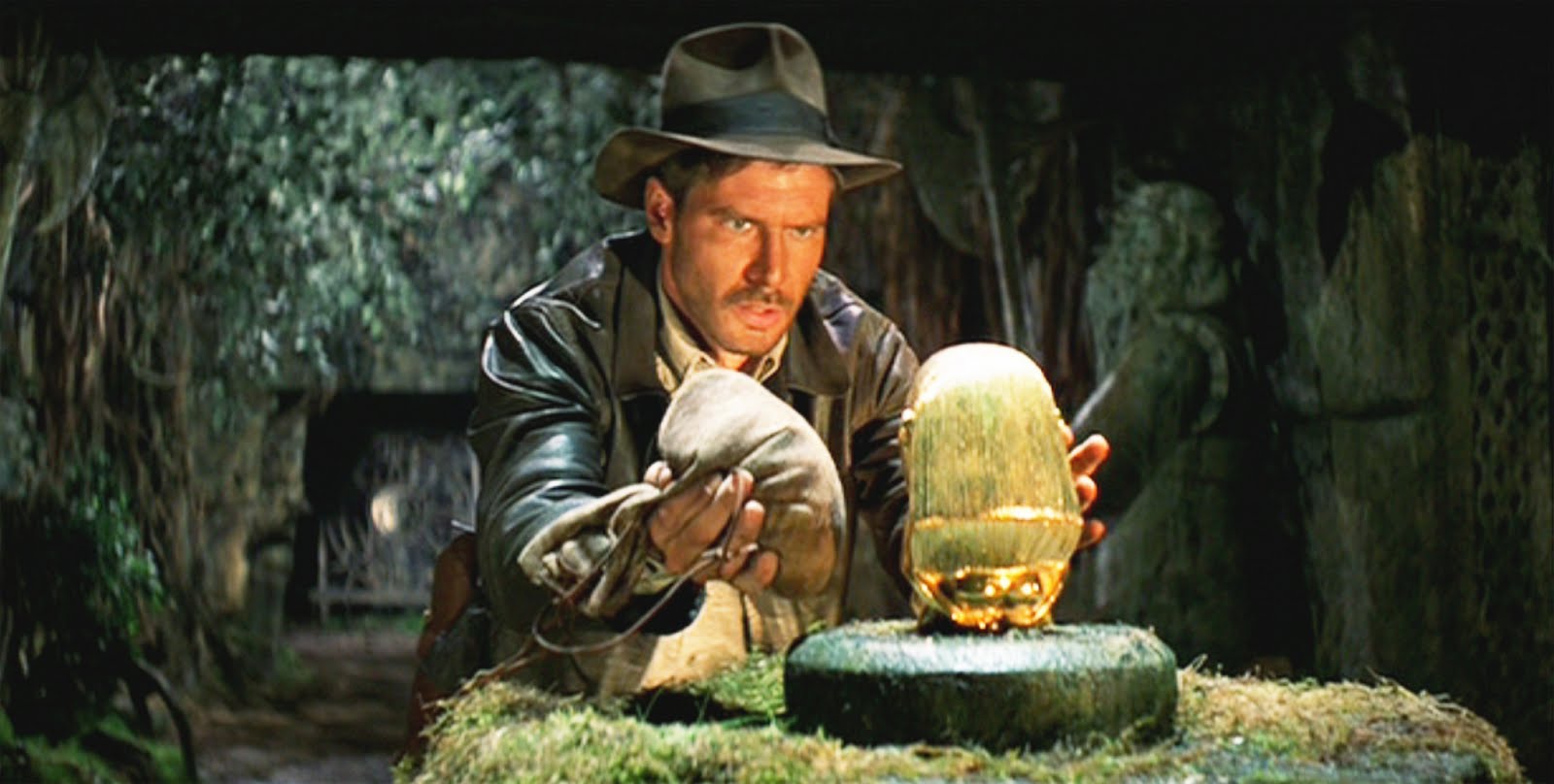 Indiana Jones (Harrison Ford) retrieves the gold idol in Raiders of the Lost Ark (1981)