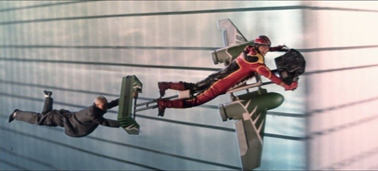 Karl Maka and Sam Hui on a rocket sled in Aces Go Places III: Our Man from Bond Street (1984)